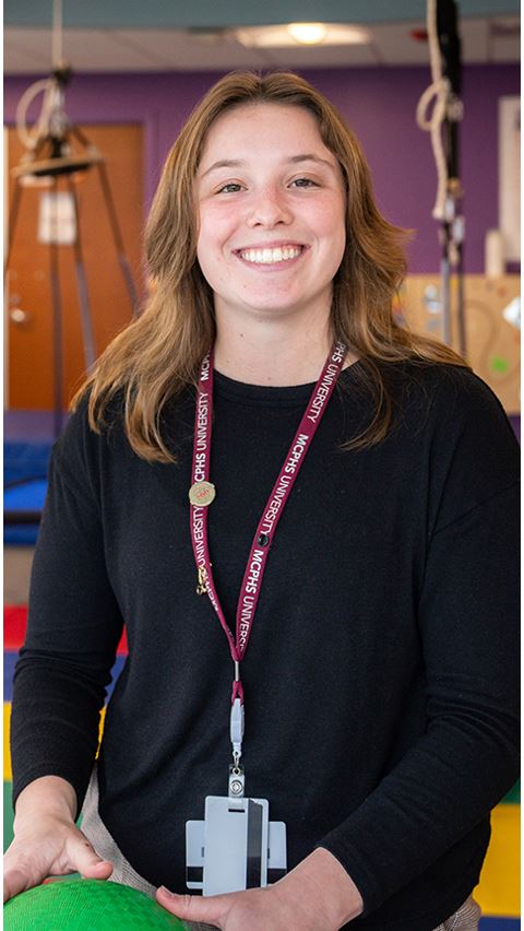 Smiling student wearing a lanyard.