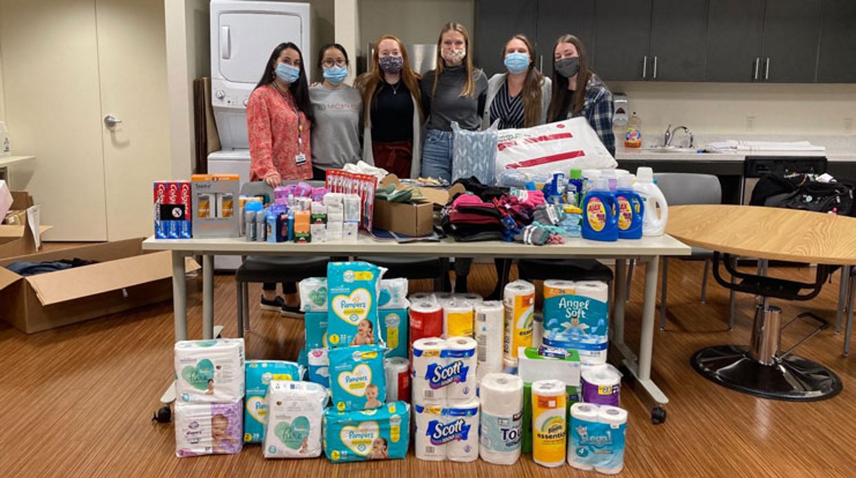 occupational therapy students in front of items that they collected